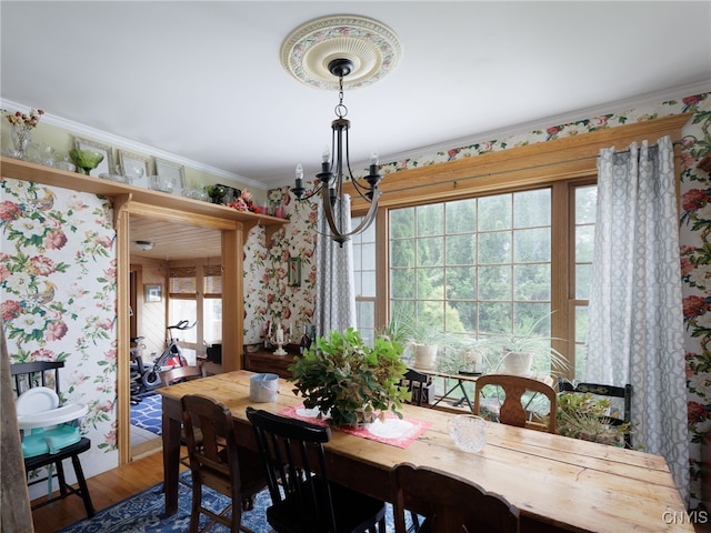 127 W St, Rutland, NY 13612 - dining area featuring a chandelier, wallpapered walls, wood finished floors, and ornamental molding