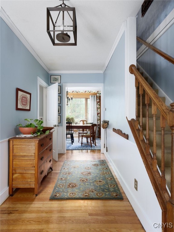 127 W St, Rutland, NY 13612 - hallway featuring crown molding, stairway, light wood-type flooring, and baseboards