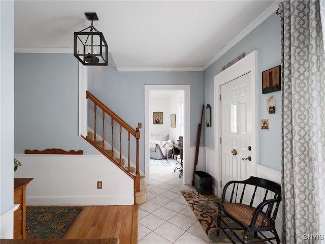 127 W St, Rutland, NY 13612 - entrance foyer with crown molding, stairway, and wainscoting