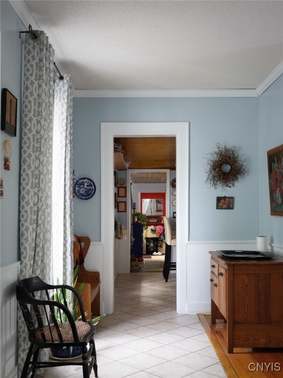 127 W St, Rutland, NY 13612 - hallway with crown molding, a wainscoted wall, and light tile patterned floors