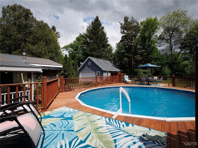 127 W St, Rutland, NY 13612 - view of swimming pool featuring a deck, an outdoor structure, and view of wooded area