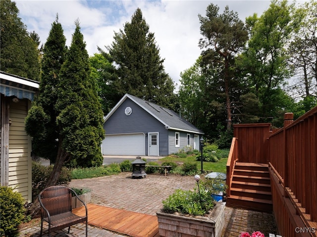 127 W St, Rutland, NY 13612 - wooden deck featuring an outbuilding, a detached garage, stairway, and a patio