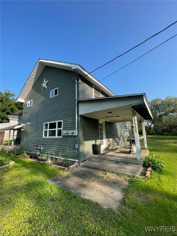 13209 Miller Ave, Sardinia, NY 14030 - rear view of house featuring a yard, a patio, and a ceiling fan