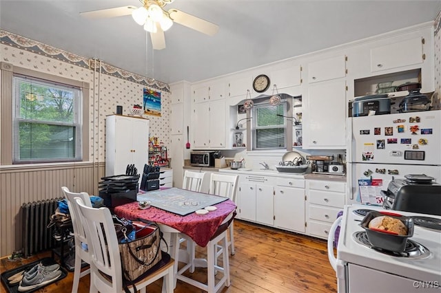 119 Charles Ave, Geddes, NY 13209 - kitchen featuring white appliances, radiator, and white cabinets