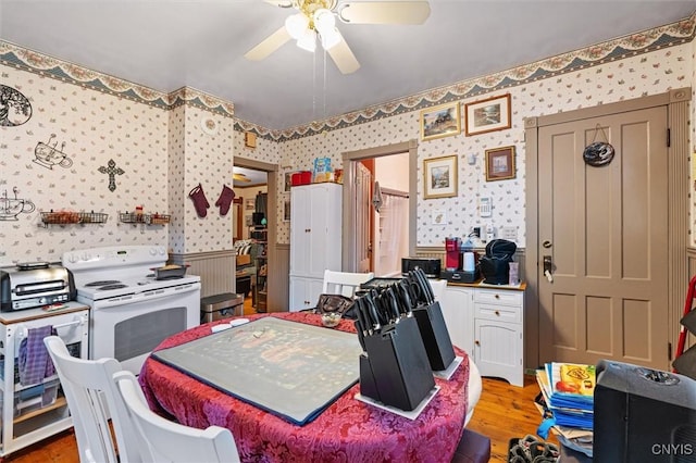119 Charles Ave, Geddes, NY 13209 - kitchen with wallpapered walls, electric stove, ceiling fan, and wood finished floors