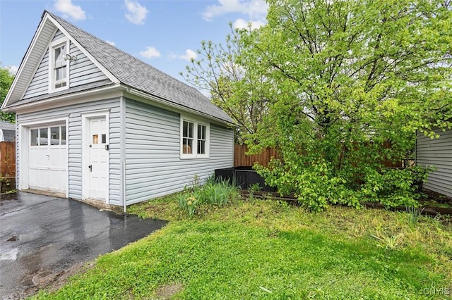 119 Charles Ave, Geddes, NY 13209 - view of side of property with a detached garage, an outdoor structure, a shingled roof, and fence
