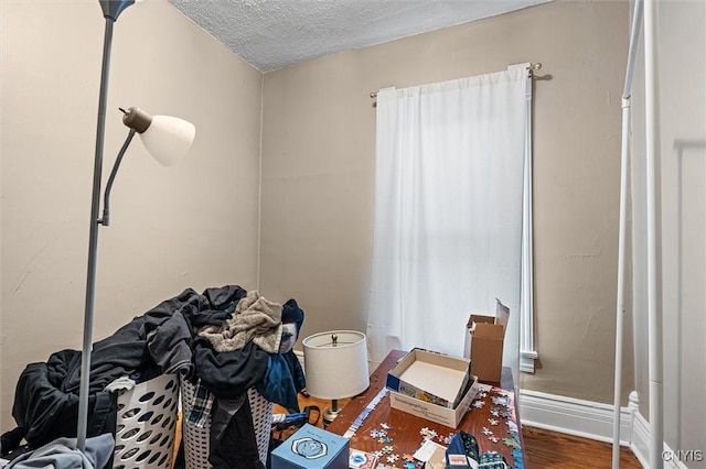 119 Charles Ave, Geddes, NY 13209 - office area featuring wood finished floors, a textured ceiling, and baseboards