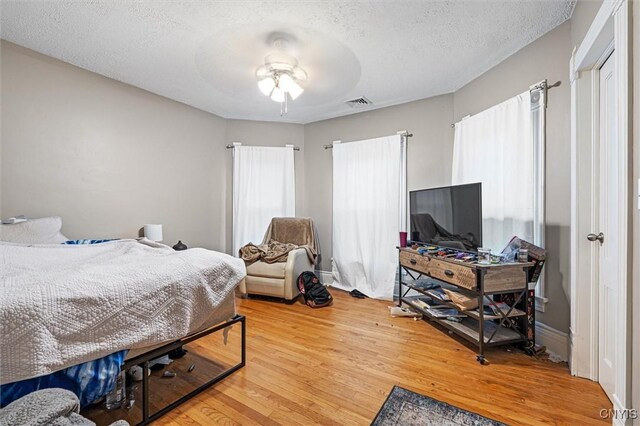 119 Charles Ave, Geddes, NY 13209 - bedroom with light wood-style flooring and a textured ceiling