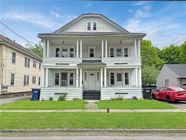 236 N Midler Ave, Syracuse, NY 13206 - view of front of home featuring a porch, a front lawn, a shingled roof, and a balcony