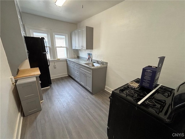 236 N Midler Ave, Syracuse, NY 13206 - kitchen featuring black appliances, gray cabinets, wood finished floors, light countertops, and baseboards