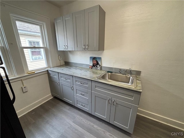 236 N Midler Ave, Syracuse, NY 13206 - kitchen featuring gray cabinets, a sink, dark wood-style floors, and baseboards