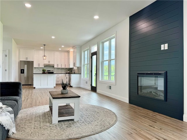 4 Brookwood Hills Dr, Big Flats, NY 14845 - living area with light wood-style flooring, baseboards, recessed lighting, and a large fireplace