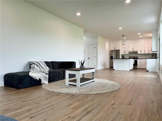 4 Brookwood Hills Dr, Big Flats, NY 14845 - living area featuring light wood-style floors, baseboards, and recessed lighting
