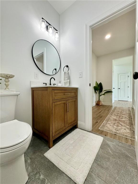 4 Brookwood Hills Dr, Big Flats, NY 14845 - bathroom featuring vanity, baseboards, and toilet
