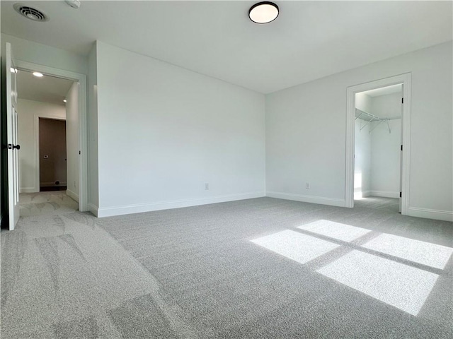 4 Brookwood Hills Dr, Big Flats, NY 14845 - unfurnished bedroom featuring light carpet, baseboards, a walk in closet, and a closet