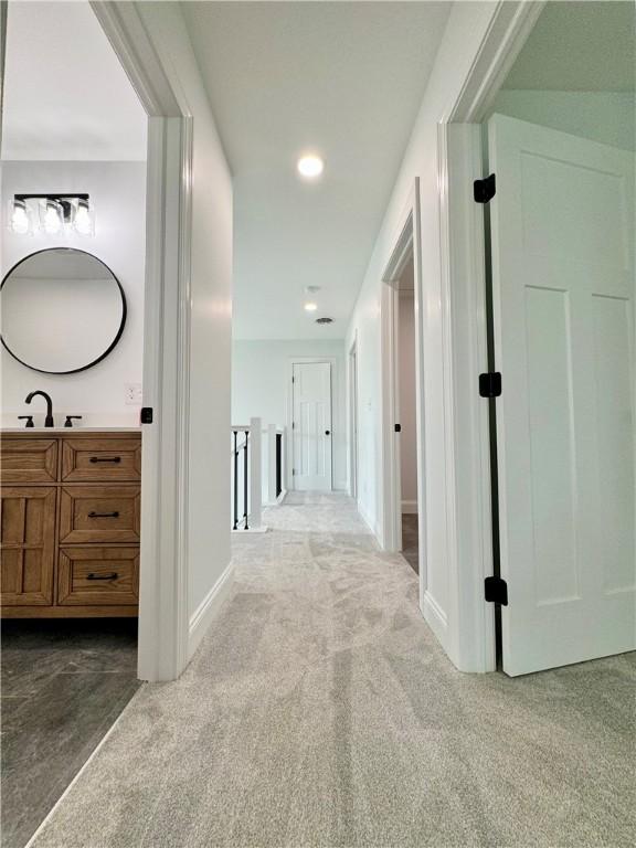 4 Brookwood Hills Dr, Big Flats, NY 14845 - hall with dark carpet, a sink, baseboards, and recessed lighting