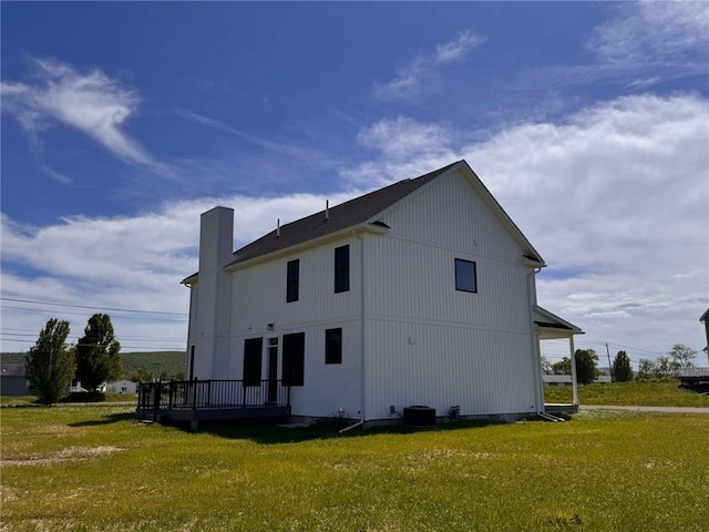4 Brookwood Hills Dr, Big Flats, NY 14845 - back of property featuring a chimney and a yard