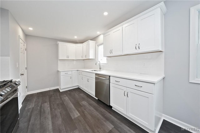 kitchen featuring dishwasher, range, a sink, light countertops, and white cabinets