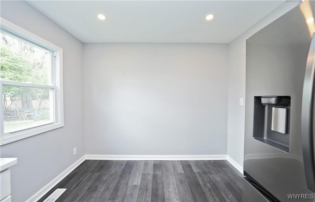 spare room with dark wood finished floors, baseboards, and recessed lighting