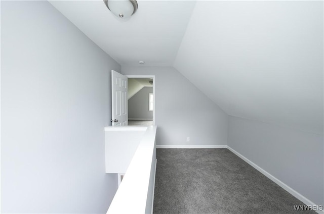 additional living space with vaulted ceiling, carpet flooring, and baseboards