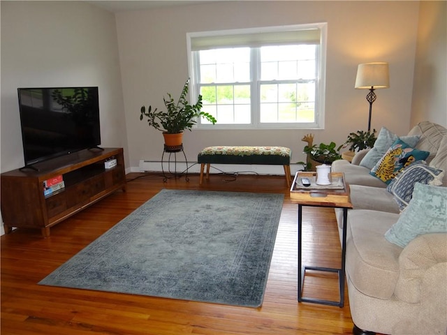 129 Daffodil Dr, Horseheads, NY 14845 - living room with wood finished floors, a baseboard heating unit, and baseboards