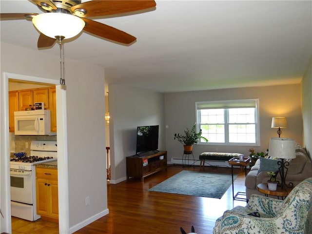 129 Daffodil Dr, Horseheads, NY 14845 - living area with light wood-style flooring, baseboard heating, a ceiling fan, and baseboards