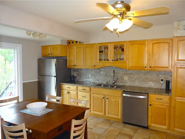 129 Daffodil Dr, Horseheads, NY 14845 - kitchen featuring appliances with stainless steel finishes, a sink, decorative backsplash, glass insert cabinets, and dark stone counters