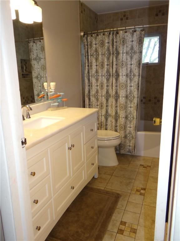 129 Daffodil Dr, Horseheads, NY 14845 - full bathroom featuring tile patterned floors, toilet, vanity, and shower / bath combination with curtain