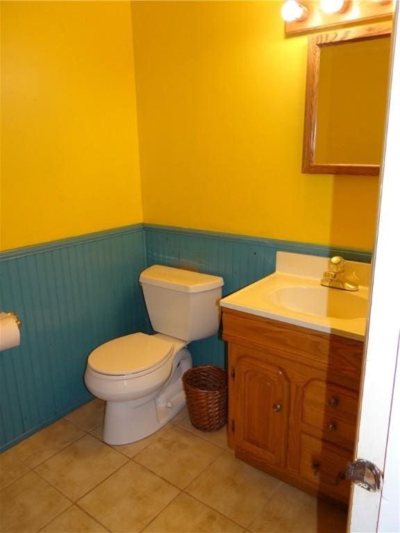 129 Daffodil Dr, Horseheads, NY 14845 - bathroom featuring a wainscoted wall, toilet, tile patterned flooring, and vanity