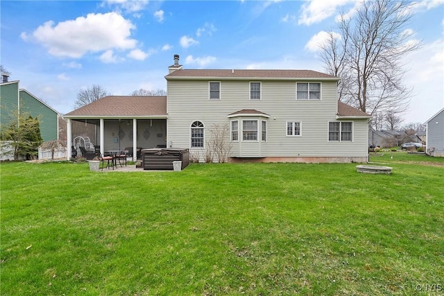 7619 Pico Ln, Lysander, NY 13027 - rear view of property with a hot tub, a chimney, a patio area, a lawn, and a sunroom