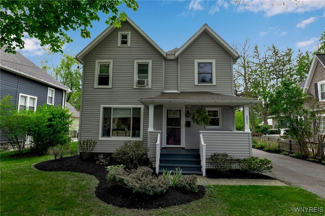 view of front of house with a porch and a front yard