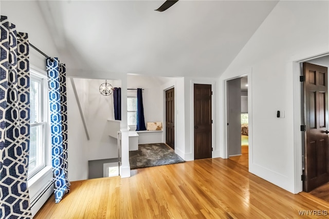 entrance foyer with lofted ceiling, wood finished floors, ceiling fan, and baseboards