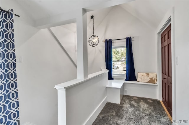 bathroom with lofted ceiling and baseboards