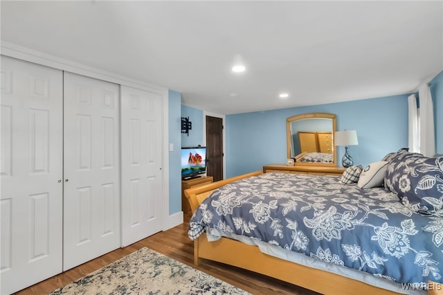 bedroom with wood finished floors, a closet, and recessed lighting