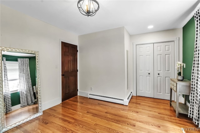 foyer with a baseboard radiator and light wood finished floors