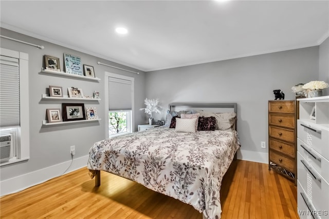 bedroom featuring ornamental molding, wood finished floors, recessed lighting, and baseboards