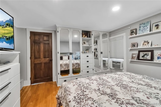 bedroom featuring light wood-style flooring, cooling unit, and recessed lighting