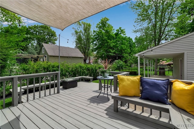 wooden deck featuring a fire pit