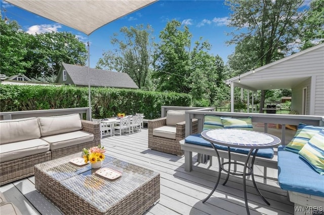 wooden terrace with an outdoor living space and outdoor dining space