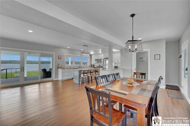 5518 Wells Bay Lakefront, North Harmony, NY 14710 - dining area with light wood finished floors, recessed lighting, baseboards, a chandelier, and french doors