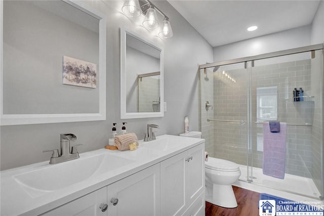 5518 Wells Bay Lakefront, North Harmony, NY 14710 - bathroom featuring a stall shower, toilet, wood finished floors, and double vanity