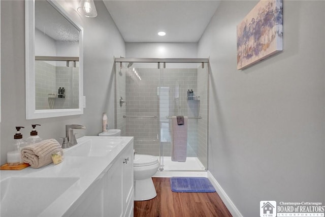5518 Wells Bay Lakefront, North Harmony, NY 14710 - full bathroom featuring wood finished floors, a stall shower, toilet, double vanity, and baseboards