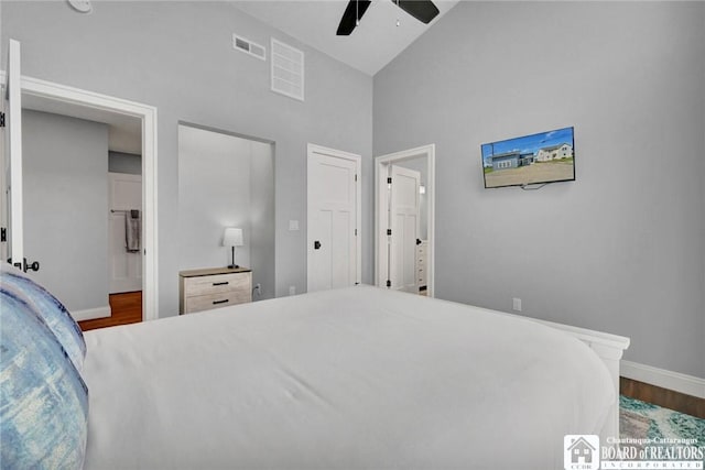5518 Wells Bay Lakefront, North Harmony, NY 14710 - bedroom featuring wood finished floors, baseboards, high vaulted ceiling, a ceiling fan, and ensuite bath