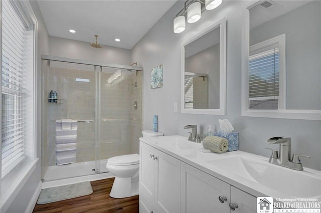 5518 Wells Bay Lakefront, North Harmony, NY 14710 - bathroom with a stall shower, wood finished floors, double vanity, toilet, and recessed lighting