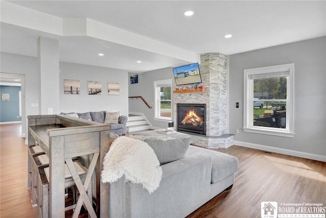 5518 Wells Bay Lakefront, North Harmony, NY 14710 - living area featuring wood finished floors, stairs, a fireplace, baseboards, and recessed lighting