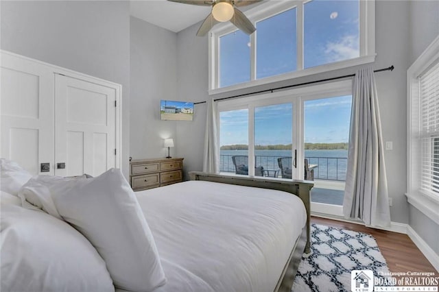 5518 Wells Bay Lakefront, North Harmony, NY 14710 - bedroom featuring a high ceiling, access to outside, wood finished floors, multiple windows, and baseboards