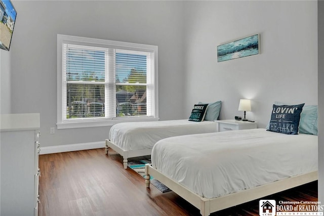5518 Wells Bay Lakefront, North Harmony, NY 14710 - bedroom with multiple windows, wood finished floors, and baseboards