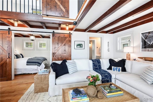 2330 Thornton S, Skaneateles, NY 13152 - living area featuring a barn door, beam ceiling, and wood finished floors