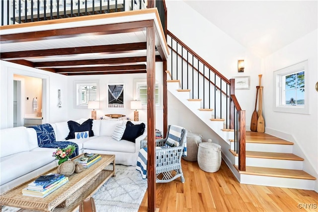 2330 Thornton S, Skaneateles, NY 13152 - living room featuring wood finished floors, stairs, healthy amount of natural light, beam ceiling, and baseboards