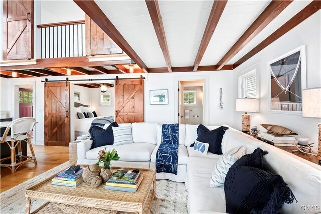 2330 Thornton S, Skaneateles, NY 13152 - living room with a barn door, beam ceiling, plenty of natural light, and wood finished floors